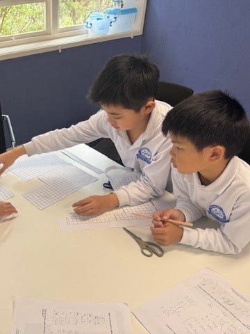 Two students working at a desk